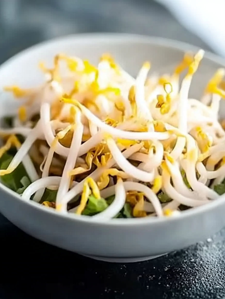 A bowl of noodles with vegetables.