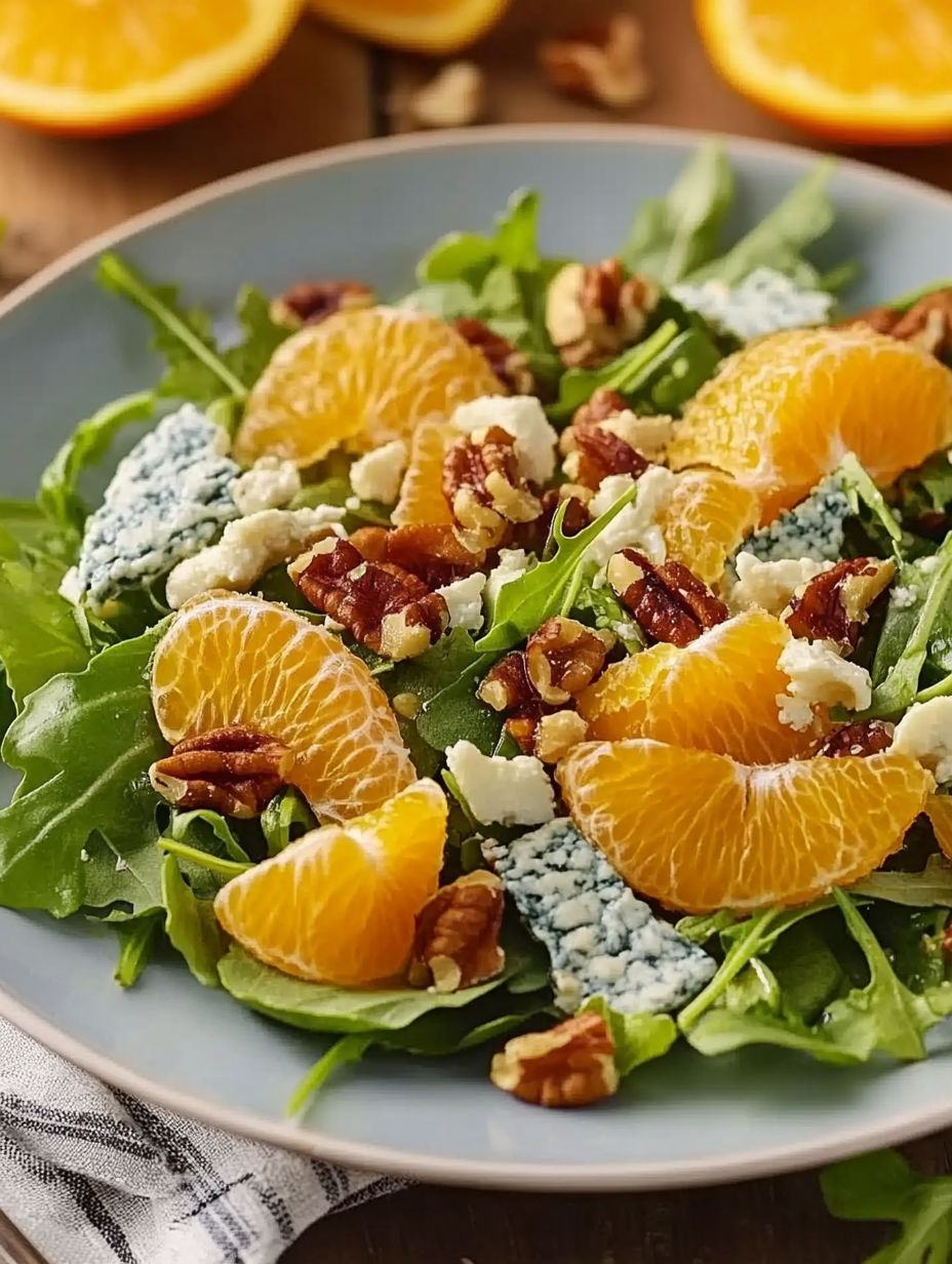 A salad with oranges, walnuts, and blue cheese.