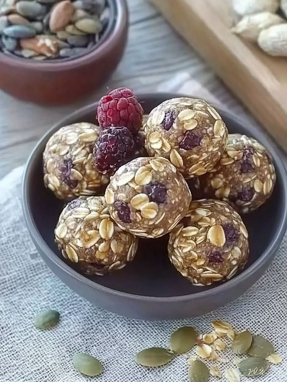 A bowl of cereal with berries on top.