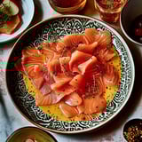 A plate of food with gravlax de saumon and vinaigrette cocktail.