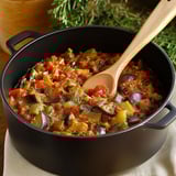 A black pot filled with a red sauce.